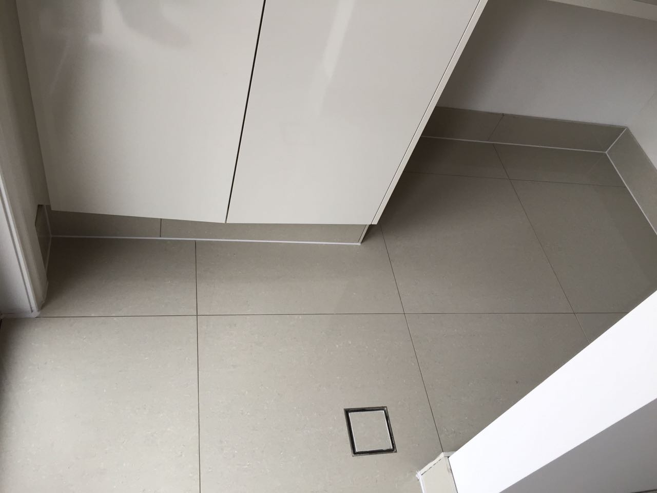 Precision tiling on a bathroom floor completed by a Harris Park tiler, bordering Parramatta