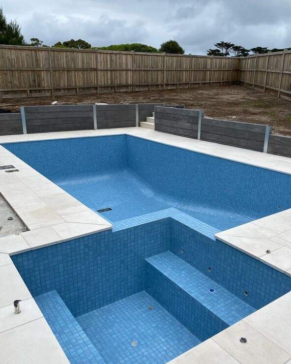 Elegant swimming pool tile work showcased during the construction phase